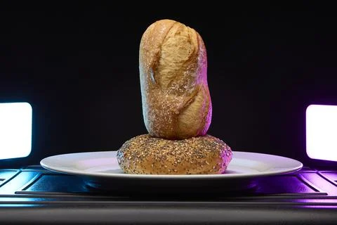 Vertical bread roll stack under neon light Foto stock