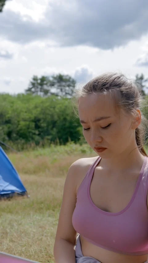 Vertical of Brown-haired lady freelancer works on laptop sitting on mat Stock Footage 276384849