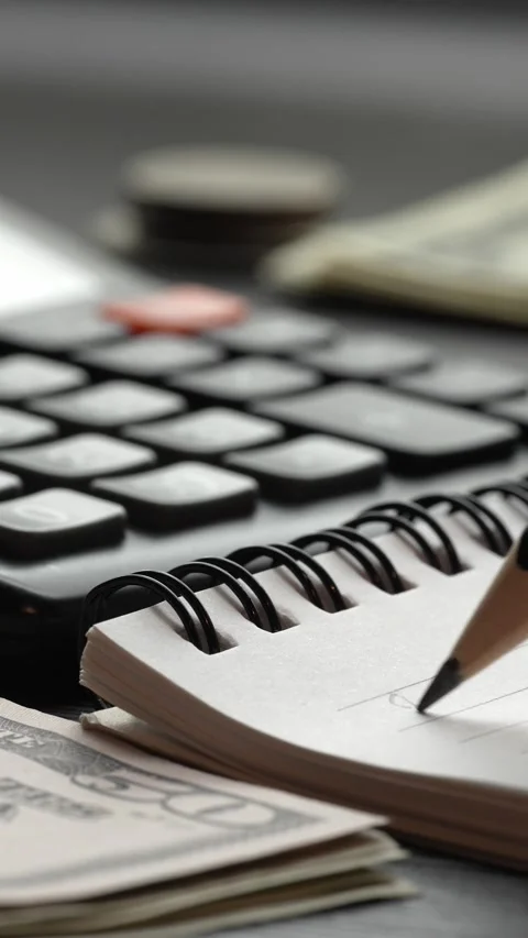 Vertical Budget Planning With Calculator Notebook and Cash Video stock 346775329