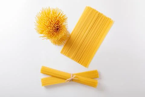 A vertical bunch and a bunch of raw spaghetti tied with string. Bundle on a Stock Photos