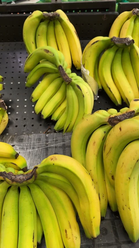 Vertical Bunches of Ripe Bananas on Pegboard Shelf Stock Footage 337911201