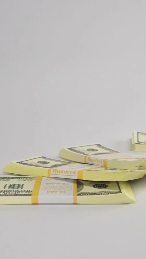 Vertical of Bundles of dollars falling on white surface Stock Footage 305480141
