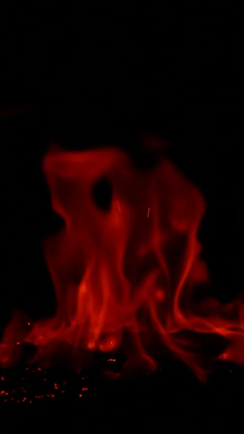 Vertical burning fire flame on ground isolated on black background, slow motion Stock Footage 306344896