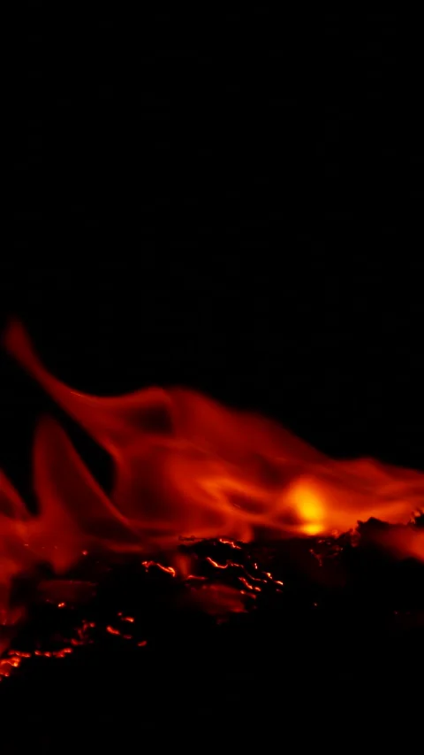 Vertical burning fire flame on ground isolated on black background, slow motion Stock Footage 308906591