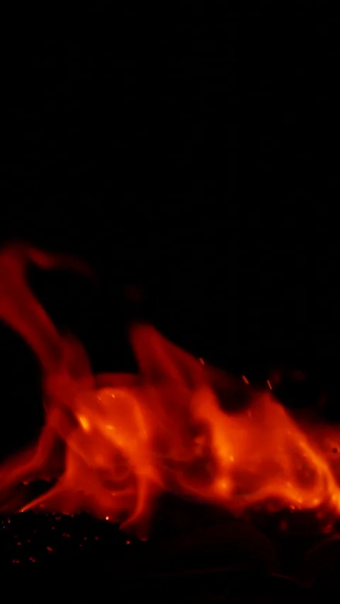 Vertical burning fire flame on ground isolated on black background, slow motion Stock Footage 309271658