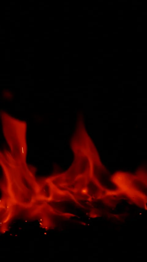 Vertical burning fire flame on ground isolated on black background, slow motion Stock Footage 312111392