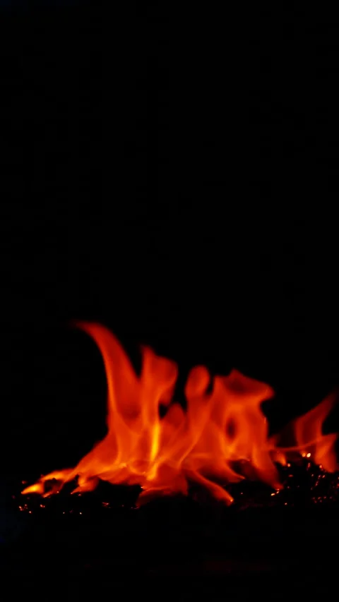 Vertical burning fire flame on ground isolated on black background, slow motion Stock Footage 312796911