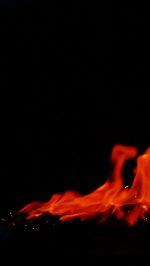 Vertical burning fire flame on ground isolated on black background, slow motion Stock Footage 313791231