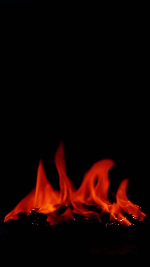 Vertical burning fire flame on ground isolated on black background, slow motion Stock Footage 314090880