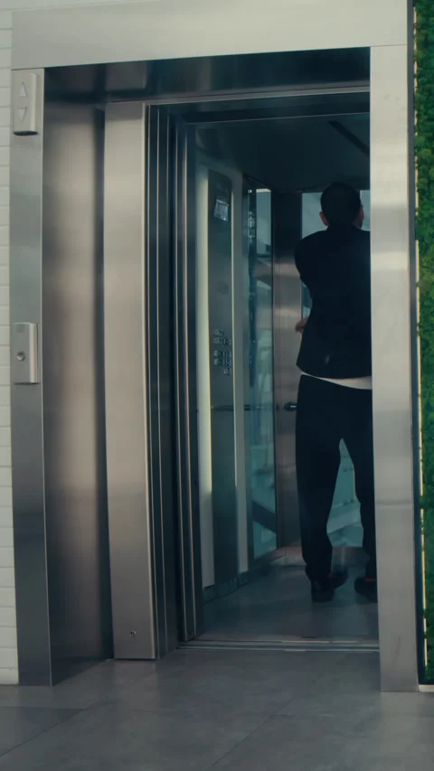 Vertical of Businessman Dancing in Elevator Stock Footage 287159642