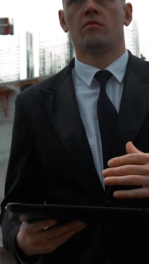 Vertical of Businessman using digital pad near new construction Stock Footage 305484632