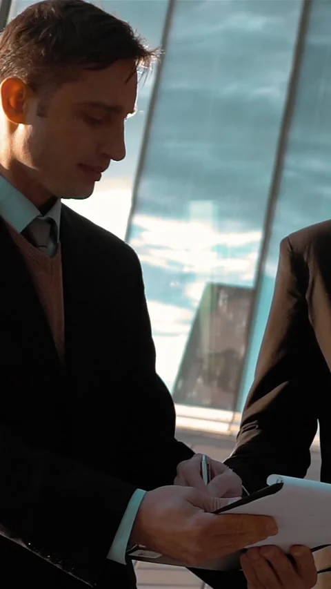 Vertical of Businessman writing documents Stock Footage 305508865