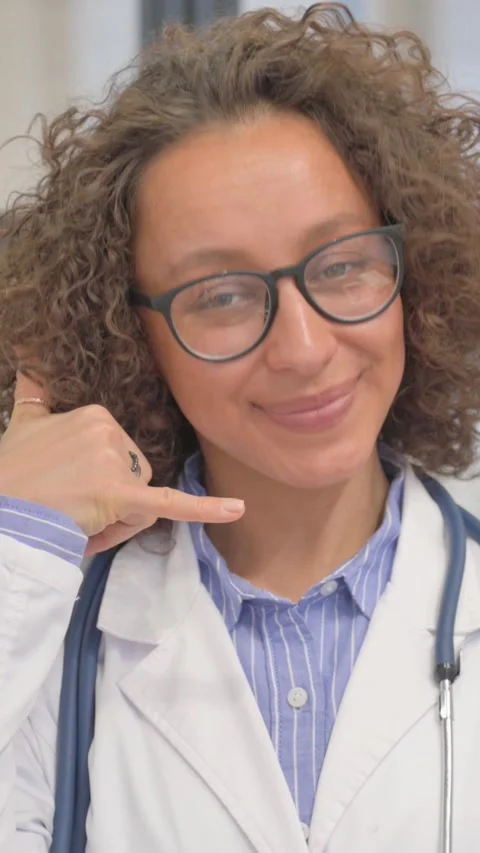 Vertical, Call Me for Help Gesture by Hispanic Female Doctor Video stock 325577821