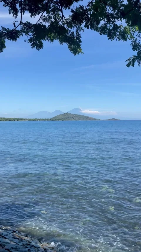 Vertical Calm Blue Sea and Mountains Bali Stock Footage 335906708