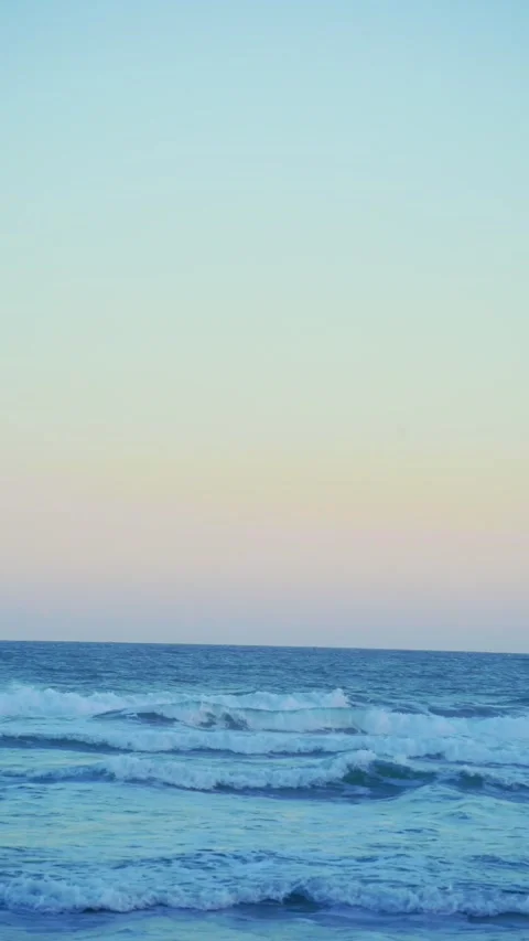 Vertical Calm Ocean Under Pastel Sky Stock Footage 337533609