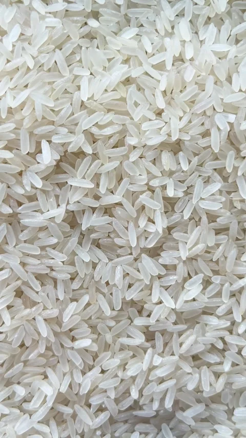 Vertical camera flyover above raw white rice grains macro texture Stock Footage 336506950