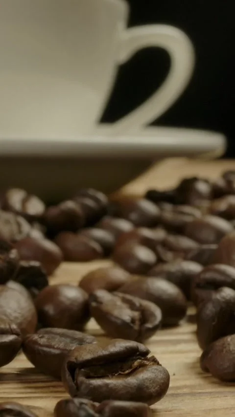 Vertical of Camera moving throw roasted coffee beans to white classical coffee Stock Footage 276924083