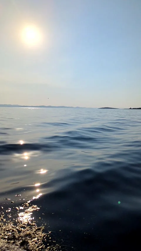 Vertical camera pan across Adriatic Sea with distant island in Croatia Stock Footage 342985675