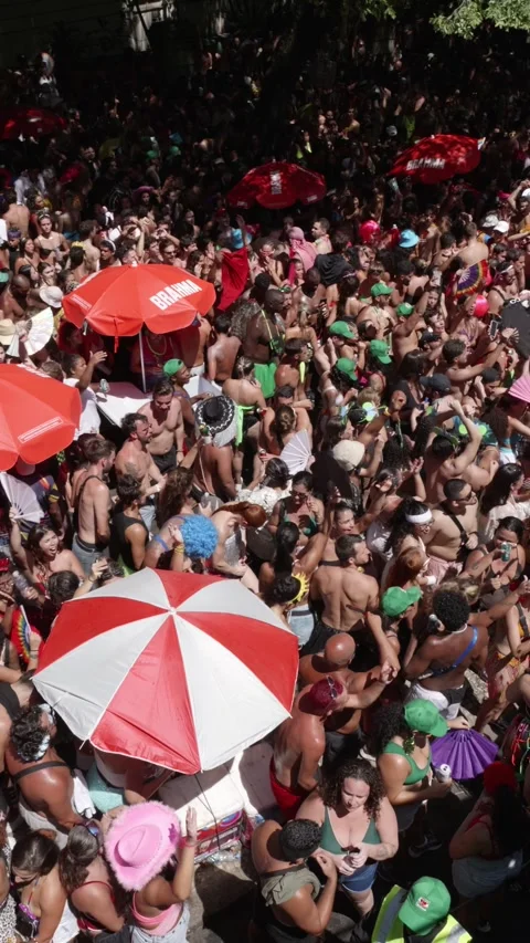 Vertical camera pans left over people dancing in a dense Rio de Janeiro Stock Footage 336589878