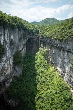 Vertical canyon with steep cliffs and lush greenery Stock Photos