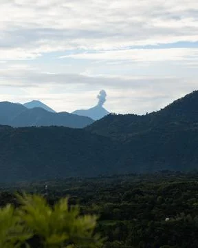 Vertical capture of large volcano erupting in guatemalan countryside in cen.. Stock Photos