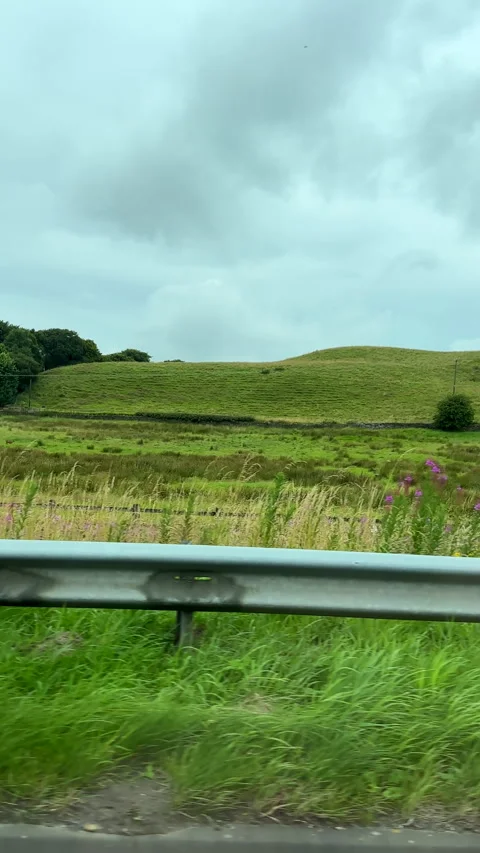 Vertical. Car side window view driving road A56 near Rising Bridge. Vídeos de archivo 281712820