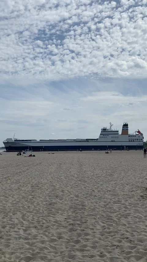 Vertical - Cargo Ferry Sailing Past Travemunde Beach Germany May 10 2020⁠ Stockbeeldmateriaal 345248090