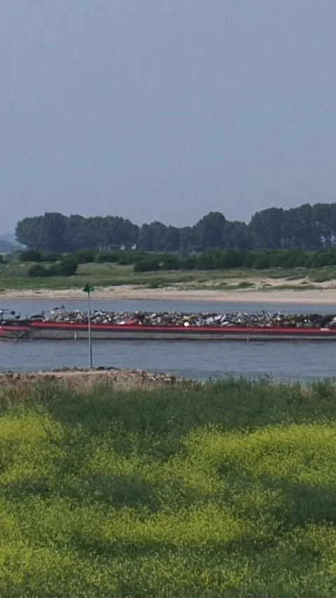 Vertical - Cargo ship metal scrap downstream River Waal near Pannerden Stock Footage 308463344