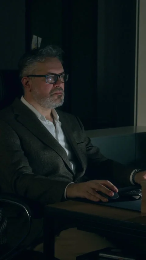 Vertical of Caucasian Businessman Working on Computer in Dark Office Stock Footage 331871490