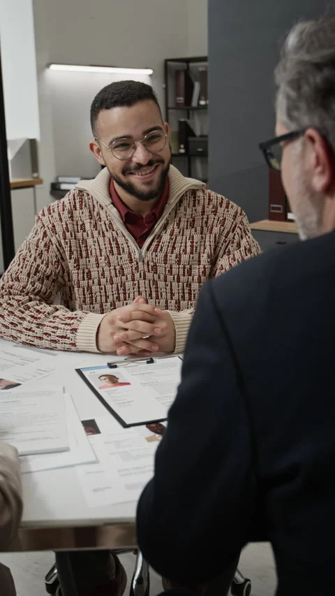 Vertical of Cheerful Candidate Talking with Two HR Managers during Job Interview Stock Footage 330521799