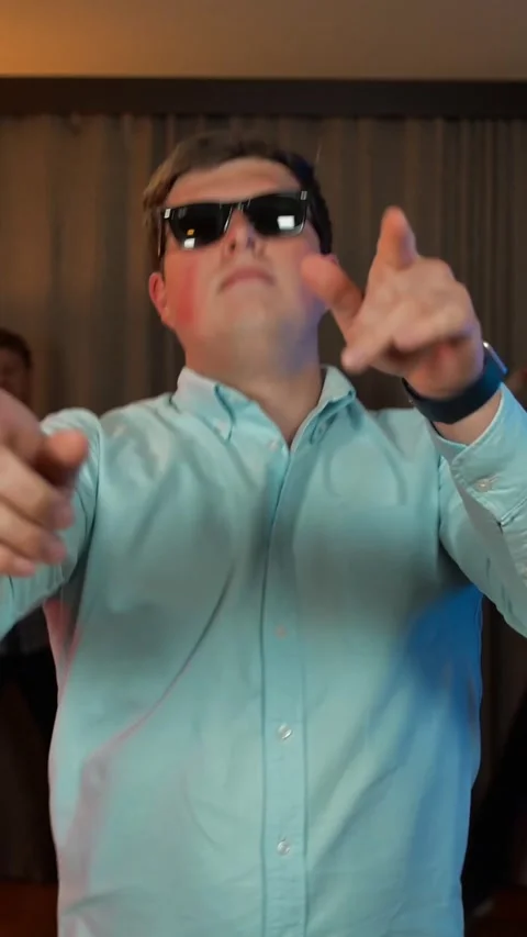 Vertical of Cheerful nerd guy with glasses dancing and partying. Video stock 278483312