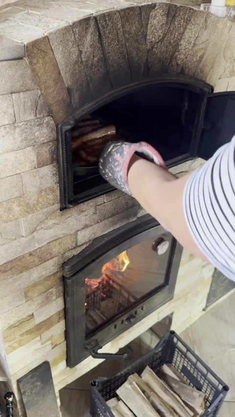 Vertical - Chef Putting Tray With Sausages Into Brick Wood Oven Stock Footage 345250525