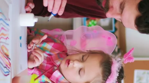 Vertical child applique man helping girl hobby Stock Footage 255183957