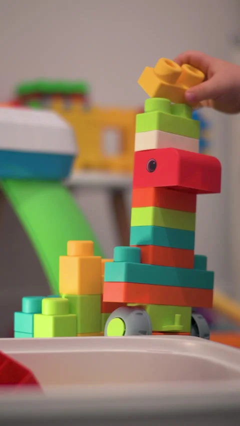 Vertical Child Hand Adding Colorful Plastic Blocks to a Growing Tower Stock-Footage 330970915