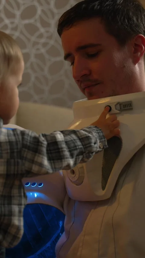 Vertical of A child will press buttons on an astronaut's costume Stock Footage 275624759