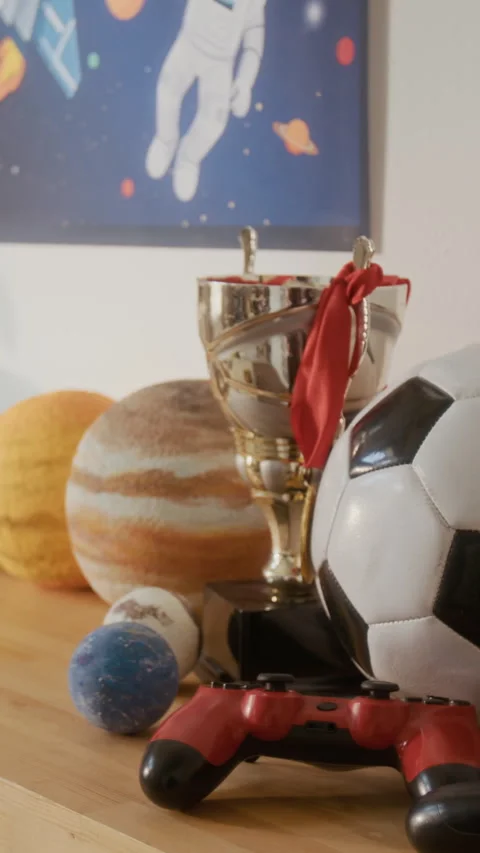Vertical of Childs Bedroom Shelf Displaying Game Controller with Trophy Stock Footage 336173992