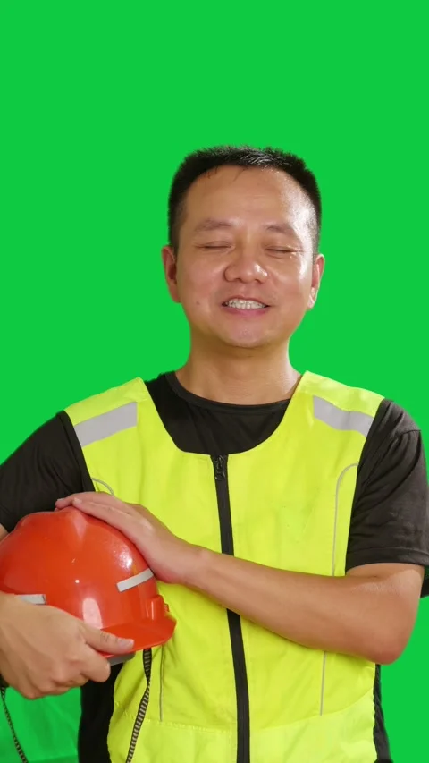 Vertical Chinese construction worker holds red safety hard hat and smiles Stock Footage 343606622