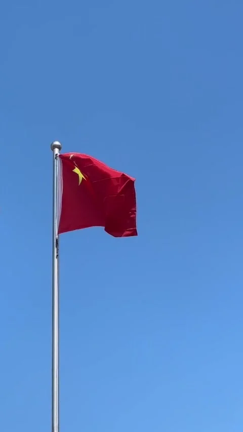 Vertical Chinese flag waving under clear blue sky Stock Footage 307571399