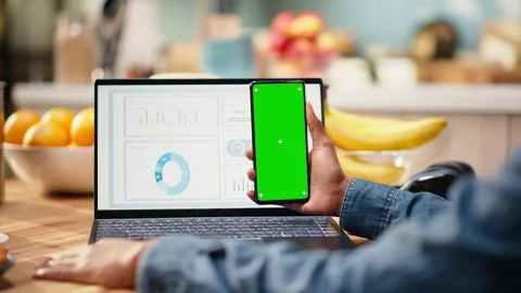 Vertical chroma key screen on smartphone used at home in kitchen Stock Footage 344248261