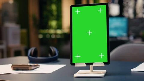 Vertical chroma key screen tablet in contemporary empty office workspace Stock Photos