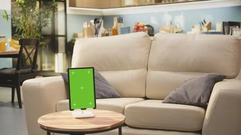 Vertical chroma key tablet in empty wooden table cozy open space Stock Photos
