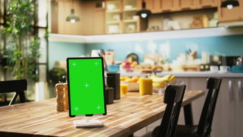 Vertical chroma key on tablet screen in empty stylish kitchen table Video stock 323331941