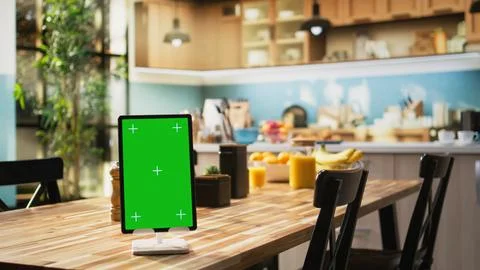 Vertical chroma key on tablet screen in empty stylish kitchen table Stock Photos