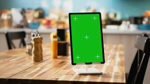 Vertical chroma key on tablet screen in empty stylish kitchen table Foto stock