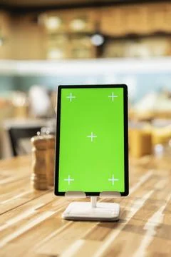 Vertical chroma key on tablet screen in empty stylish kitchen table Stock Photos