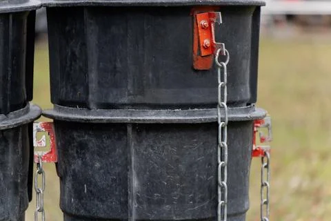 Vertical chute columns assembled with side brackets and hanging chains Stock Photos