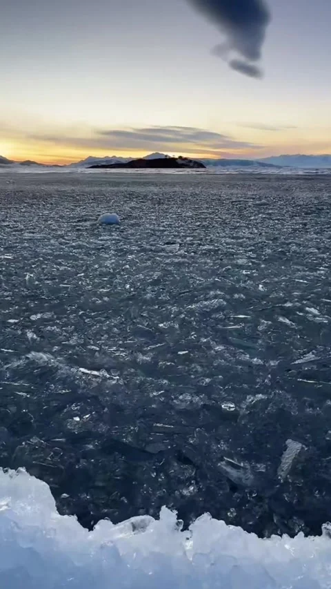 Vertical Cinematic Close-up of Floating Ice Rippling on Water Surface Stock Footage 328068058