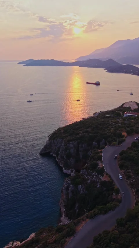 Vertical cinematic drone pan across winding coastal road in Kas Turkey Stock-Footage 345127867