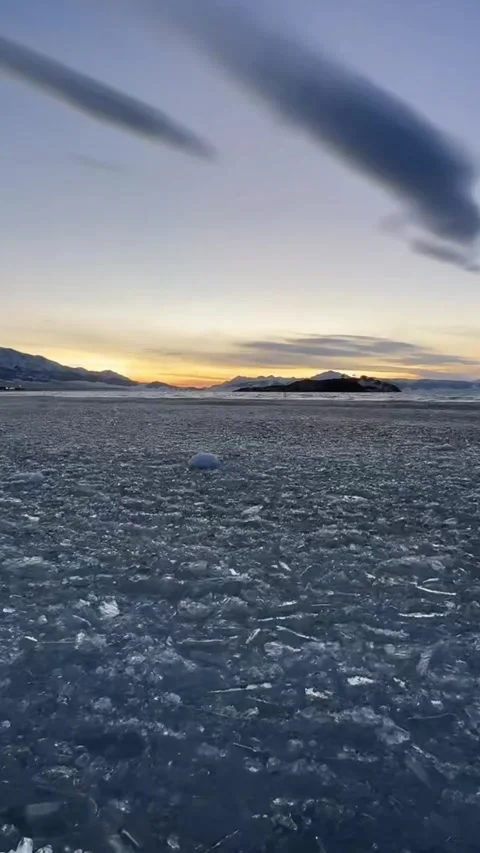 Vertical Cinematic Shot of Broken Ice Floating and Bobbing on Cold Water Stock Footage 328068344