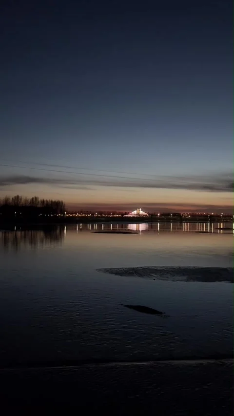 Vertical Cinematic Sunset Reflection on Rippling River Water with Distant Br Stock-Footage 333285453